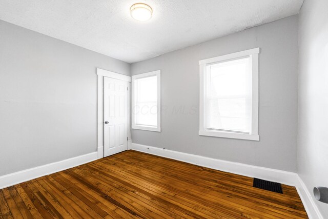 1165 Wager St Unit 1165-1167, Columbus, OH 43206 - spare room with baseboards, dark wood-type flooring, and healthy amount of natural light