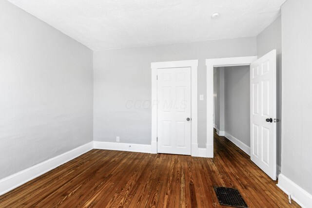 1165 Wager St Unit 1165-1167, Columbus, OH 43206 - unfurnished bedroom featuring baseboards and dark wood-style flooring