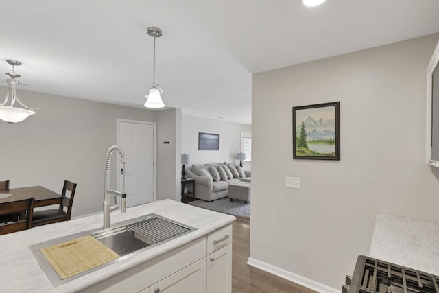 4712 Shalers Dr Unit 54A, Columbus, OH 43228 - kitchen featuring dark wood-type flooring, decorative light fixtures, white cabinets, light countertops, and a sink