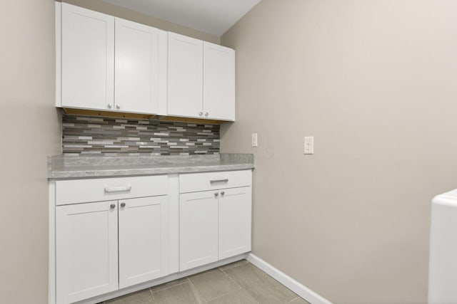 4712 Shalers Dr Unit 54A, Columbus, OH 43228 - kitchen featuring light countertops, backsplash, white cabinets, baseboards, and light tile patterned flooring