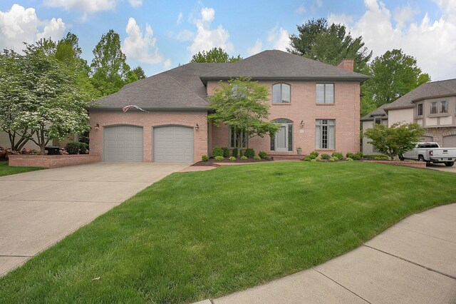 8259 Spruce Needle Ct, Columbus, OH 43235 - view of front of property featuring an attached garage, brick siding, driveway, a front lawn, and a chimney