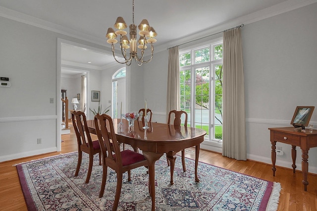8259 Spruce Needle Ct, Columbus, OH 43235 - dining area with a chandelier, crown molding, light wood finished floors, and baseboards