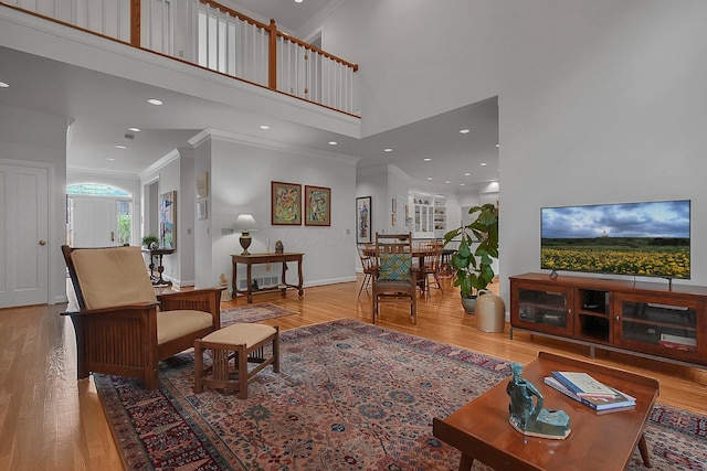 8259 Spruce Needle Ct, Columbus, OH 43235 - living room featuring ornamental molding, wood finished floors, a towering ceiling, recessed lighting, and baseboards