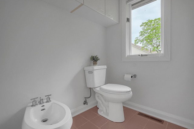 8259 Spruce Needle Ct, Columbus, OH 43235 - bathroom with healthy amount of natural light, toilet, tile patterned flooring, and baseboards