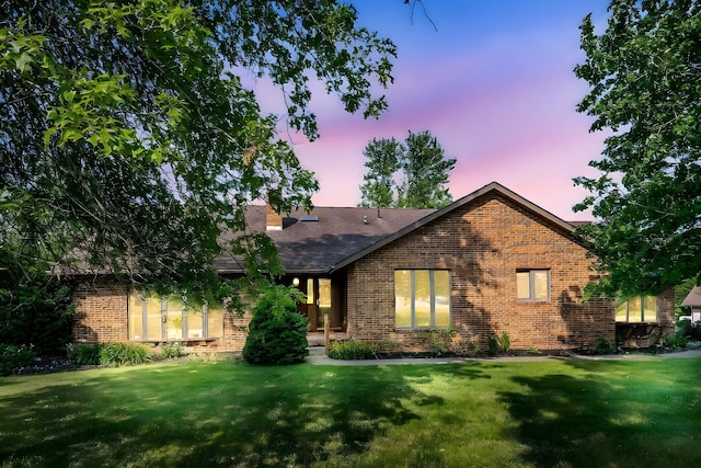 12502 Barbara Dr, Kenton, OH 43326 - ranch-style home with brick siding, a front yard, and roof with shingles