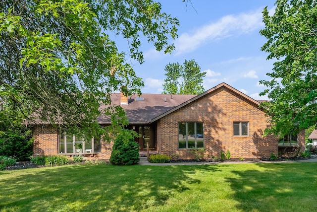 12502 Barbara Dr, Kenton, OH 43326 - view of front of home featuring brick siding, a front yard, and a shingled roof