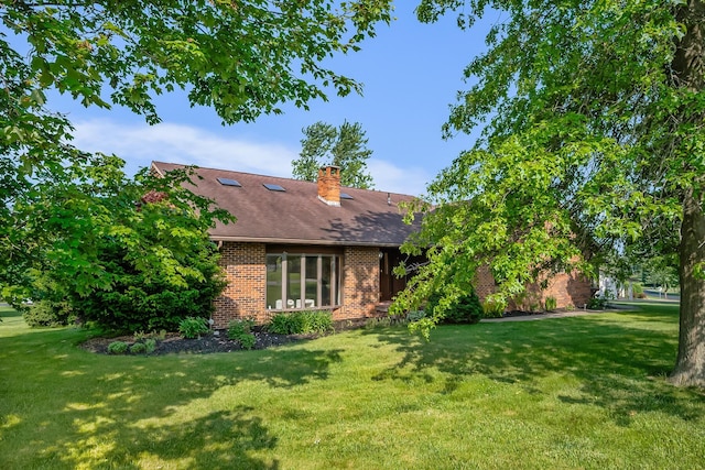 12502 Barbara Dr, Kenton, OH 43326 - view of side of home with brick siding, a lawn, a chimney, and a shingled roof