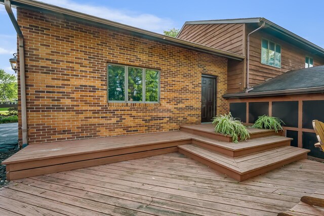 12502 Barbara Dr, Kenton, OH 43326 - rear view of property featuring a deck, a sunroom, and brick siding