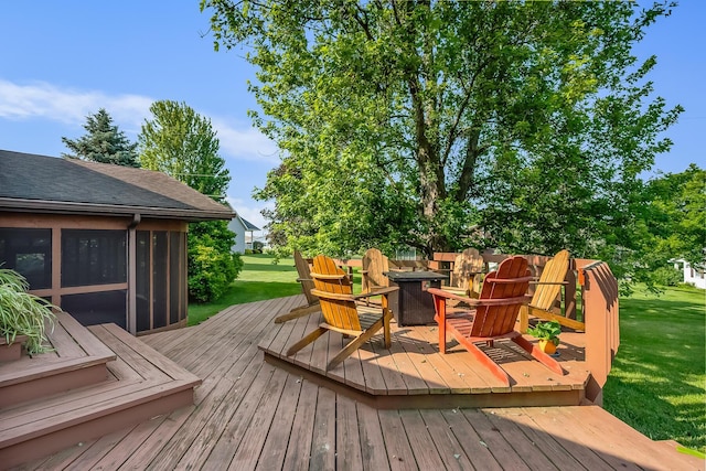 12502 Barbara Dr, Kenton, OH 43326 - wooden deck with a fire pit, a sunroom, and a lawn