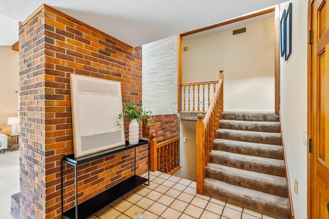 12502 Barbara Dr, Kenton, OH 43326 - stairs with a textured ceiling and tile patterned flooring