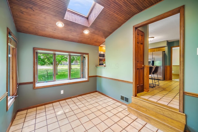 12502 Barbara Dr, Kenton, OH 43326 - unfurnished room featuring wooden ceiling, a skylight, light tile patterned floors, baseboards, and vaulted ceiling