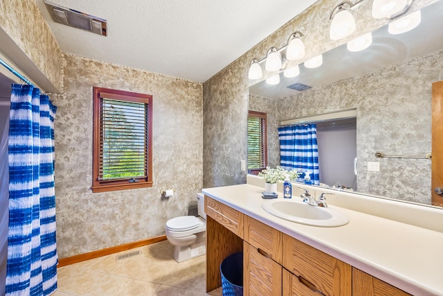 12502 Barbara Dr, Kenton, OH 43326 - full bathroom with healthy amount of natural light, toilet, tile patterned floors, vanity, and a textured ceiling