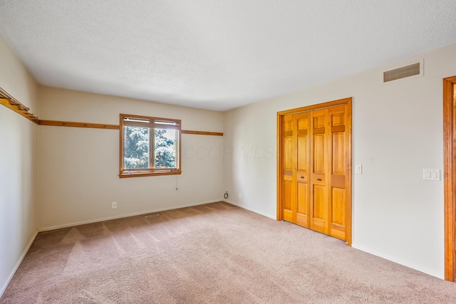 12502 Barbara Dr, Kenton, OH 43326 - unfurnished bedroom featuring carpet flooring, baseboards, and a textured ceiling