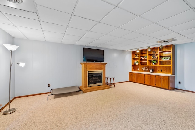 12502 Barbara Dr, Kenton, OH 43326 - below grade area featuring carpet flooring, baseboards, a fireplace with raised hearth, and a drop ceiling