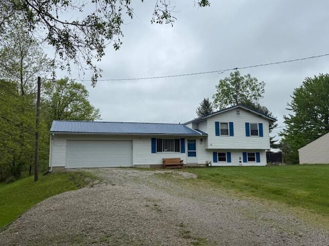 2802 County Road 26, Marengo, OH 43334 - split level home with driveway, an attached garage, metal roof, and a front lawn