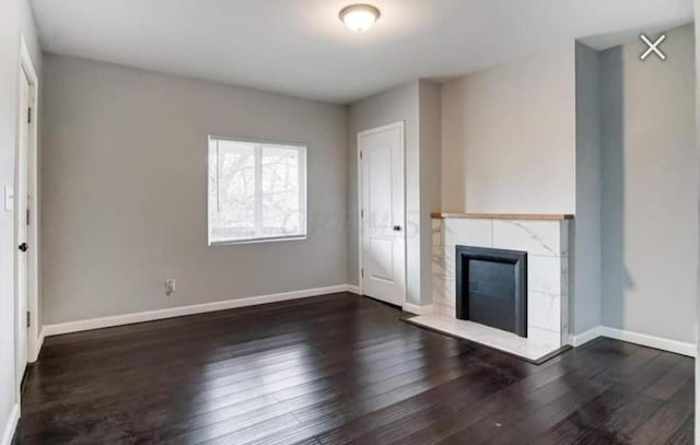 220 E Tompkins St, Columbus, OH 43202 - unfurnished living room with baseboards, wood finished floors, and a fireplace