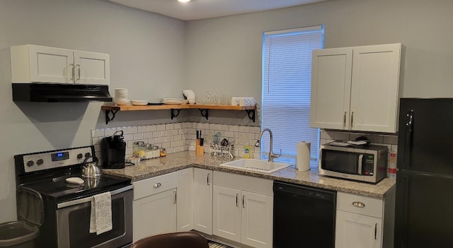 220 E Tompkins St, Columbus, OH 43202 - kitchen with black appliances, a sink, under cabinet range hood, decorative backsplash, and white cabinets