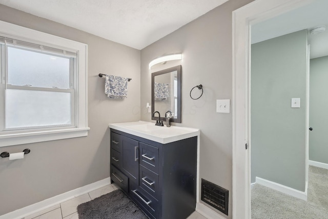 bathroom featuring baseboards, vanity, and tile patterned floors