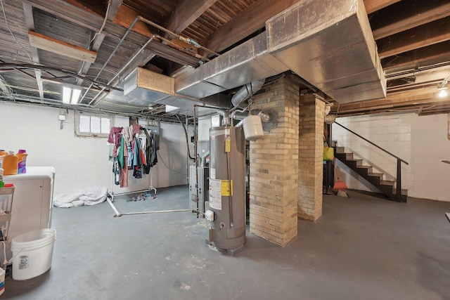 basement featuring gas water heater and stairway