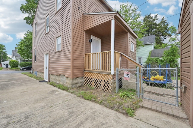 view of property exterior with fence and a gate