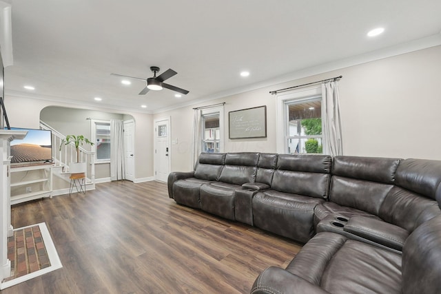 living area featuring arched walkways, ornamental molding, ceiling fan, recessed lighting, and stairs