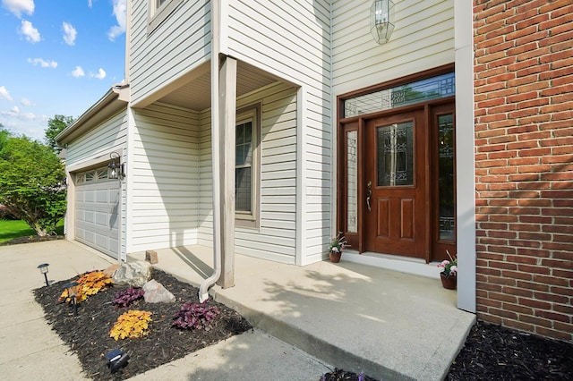 property entrance with driveway and covered porch