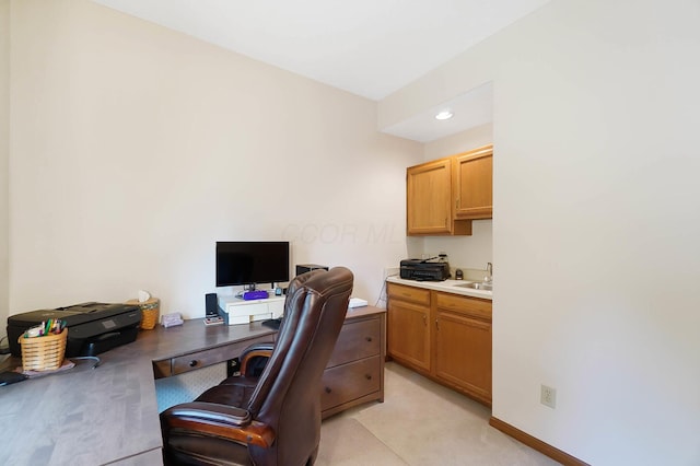office featuring a sink and baseboards
