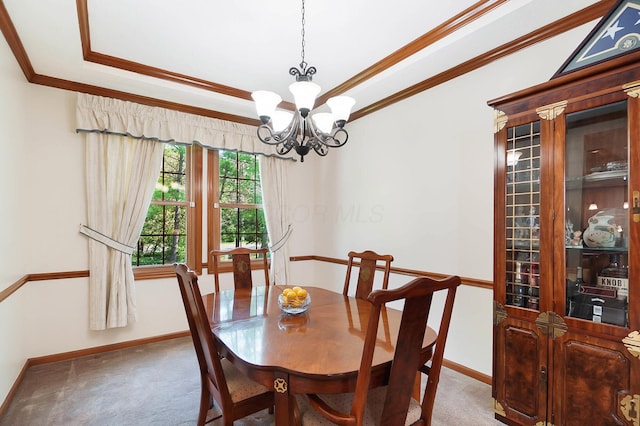 dining room with light colored carpet, crown molding, baseboards, a chandelier, and a raised ceiling