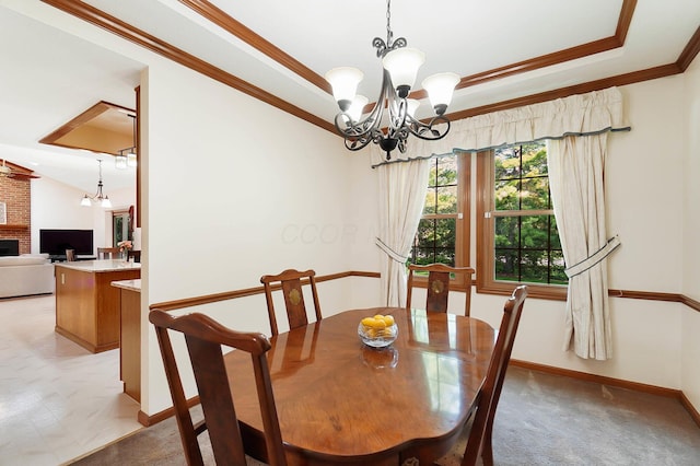 dining space with a chandelier, ornamental molding, a fireplace, baseboards, and a tray ceiling