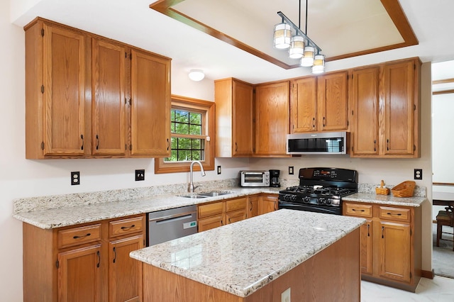 kitchen with a sink, stainless steel appliances, light stone countertops, and pendant lighting