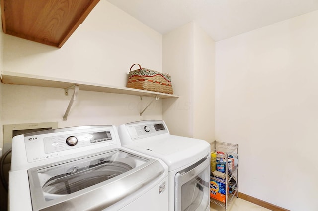 clothes washing area featuring separate washer and dryer and baseboards