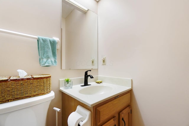 bathroom featuring toilet and vanity