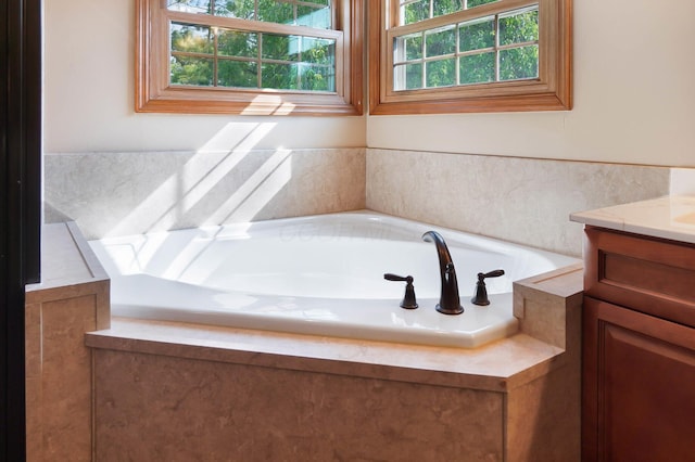 bathroom featuring a bath and vanity