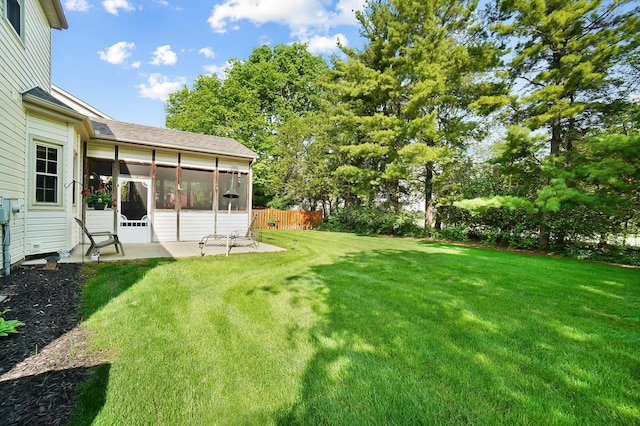 view of yard featuring a sunroom and a patio area