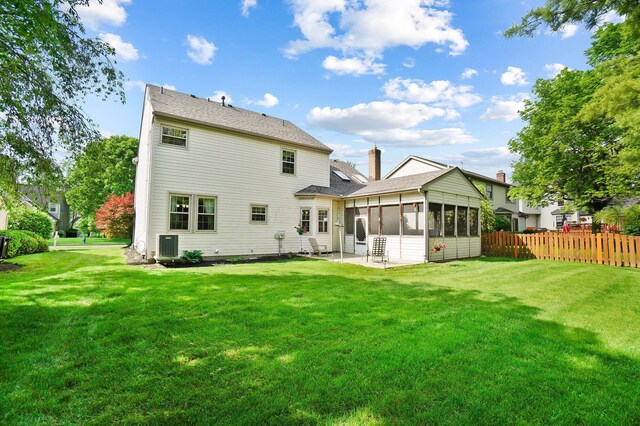 rear view of property with a sunroom and a patio area