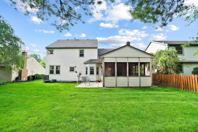 back of property with central AC unit, a patio, a sunroom, and a shingled roof