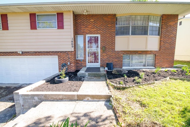 1469 Sandalwood Pl, Columbus, OH 43229 - view of front of house with brick siding and an attached garage