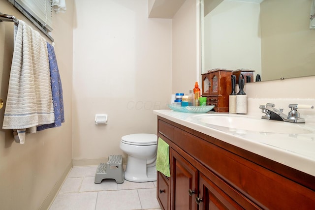 1469 Sandalwood Pl, Columbus, OH 43229 - bathroom featuring tile patterned flooring, toilet, vanity, and baseboards