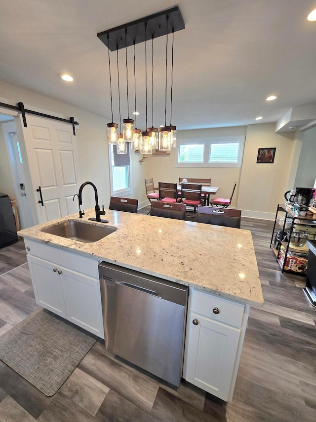 690 E Kossuth St, Columbus, OH 43206 - kitchen featuring stainless steel dishwasher, a sink, a kitchen island with sink, white cabinets, and open floor plan