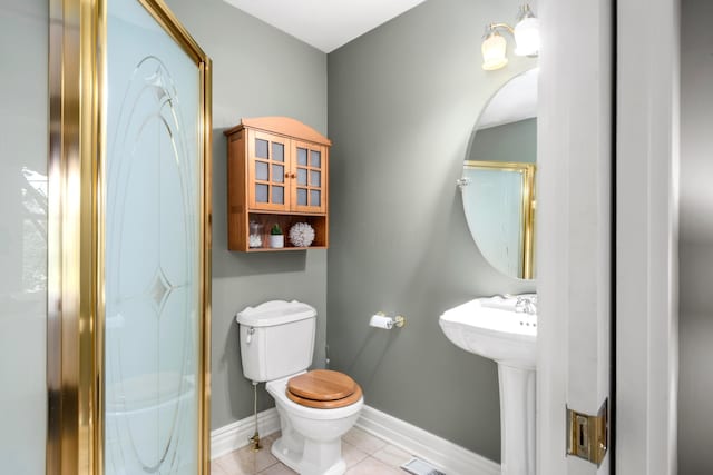 1042 Neil Ave, Columbus, OH 43201 - full bathroom featuring toilet, baseboards, an enclosed shower, and tile patterned flooring