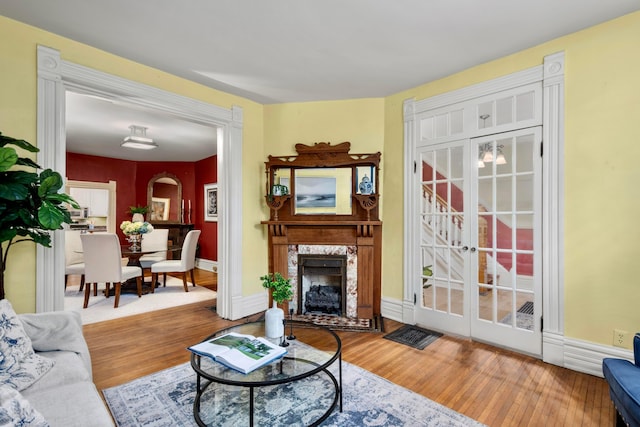1042 Neil Ave, Columbus, OH 43201 - living room with wood finished floors, a fireplace, and baseboards