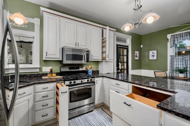 1042 Neil Ave, Columbus, OH 43201 - kitchen featuring appliances with stainless steel finishes, pendant lighting, white cabinets, and dark stone countertops