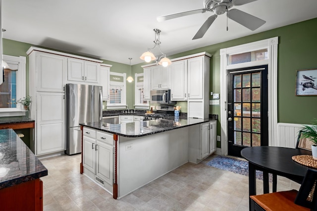 1042 Neil Ave, Columbus, OH 43201 - kitchen with appliances with stainless steel finishes, healthy amount of natural light, pendant lighting, and dark stone counters