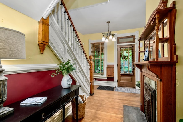 1042 Neil Ave, Columbus, OH 43201 - foyer entrance featuring light wood-style floors, a chandelier, and stairs