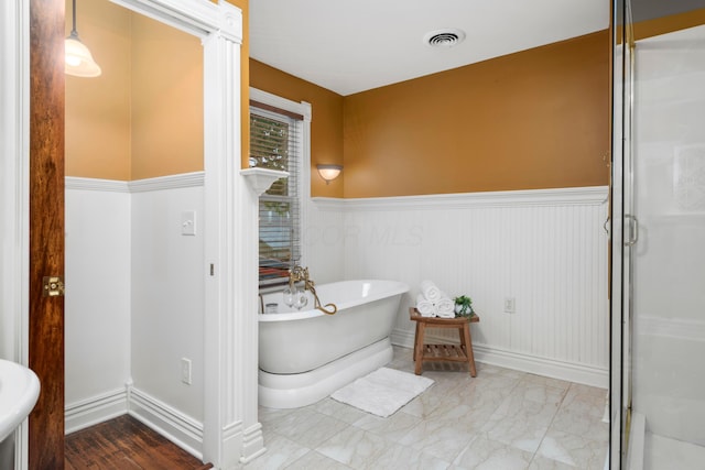 1042 Neil Ave, Columbus, OH 43201 - full bath with a wainscoted wall, a freestanding bath, and a shower stall