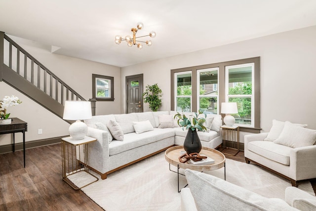 46 E Markison Ave, Columbus, OH 43207 - living area featuring stairway, dark wood-type flooring, a chandelier, and baseboards