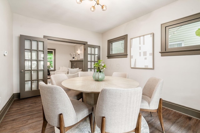 46 E Markison Ave, Columbus, OH 43207 - dining room featuring dark wood finished floors, baseboards, and a chandelier