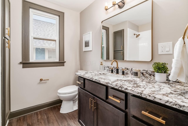 46 E Markison Ave, Columbus, OH 43207 - bathroom with wood finished floors, toilet, vanity, and a shower