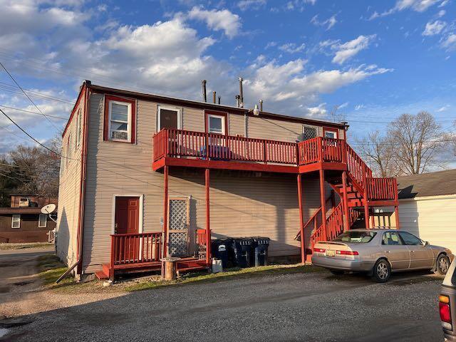 rear view of house featuring stairs