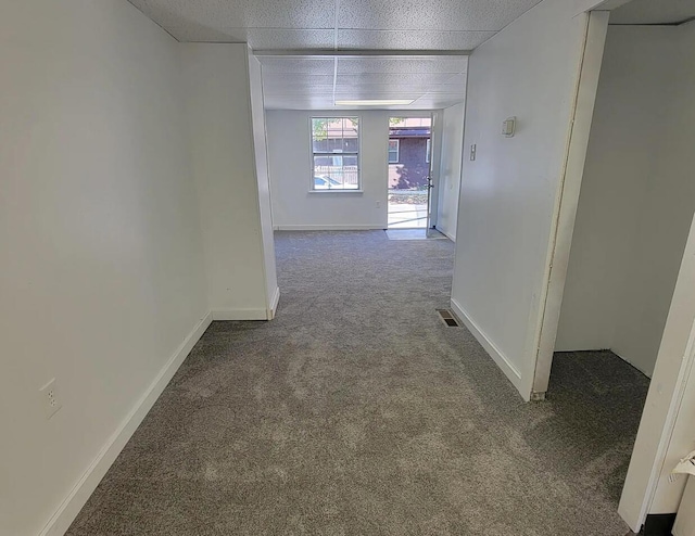 hall with carpet floors and baseboards